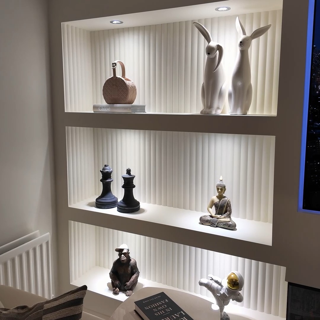 Fluted lit display shelving styled with ornaments by RV Media Walls